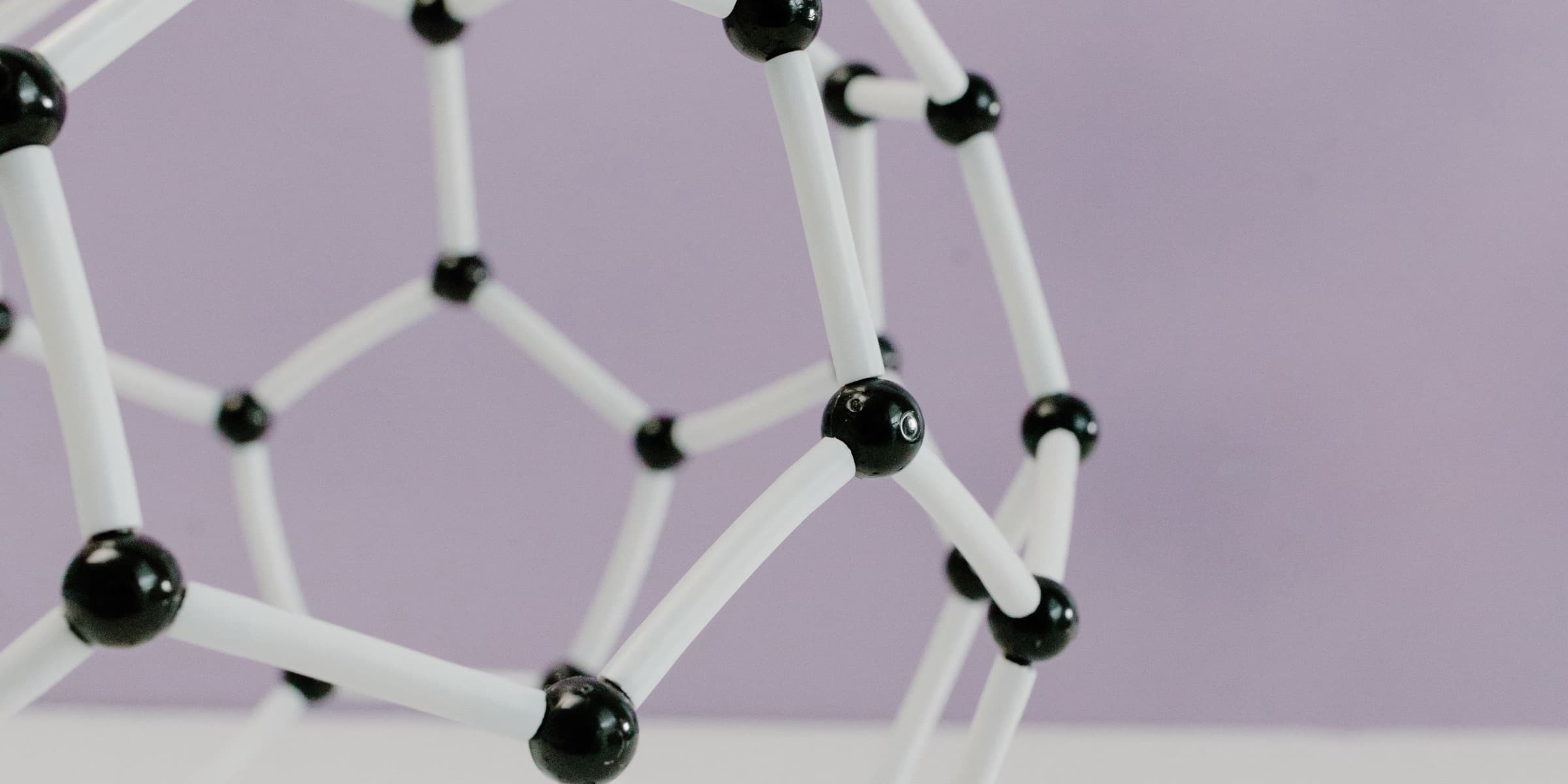 Geometric molecular model on a pastel background
